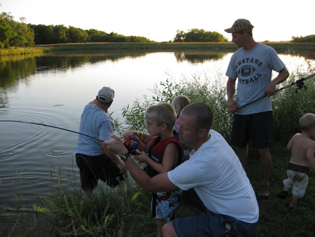 Reeling It In Eli needs daddys help. This aint no wee little sunfish!