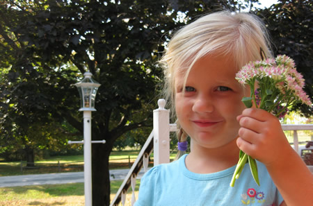The flower girl Molly loves picking flowers. Out of flower beds.